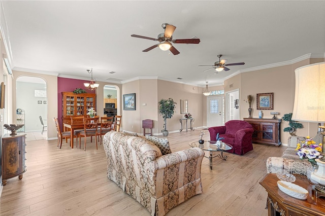 living room featuring light hardwood / wood-style flooring, ceiling fan with notable chandelier, and ornamental molding