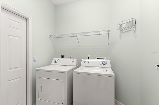 laundry area with separate washer and dryer and laundry area