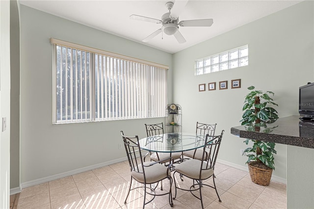 dining room featuring baseboards, ceiling fan, and tile patterned flooring