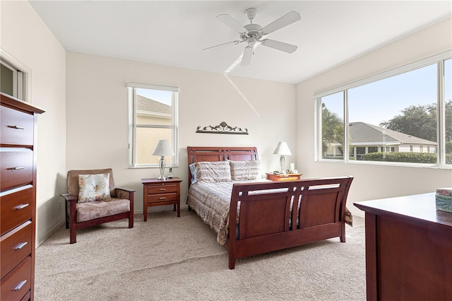 bedroom with light colored carpet and ceiling fan