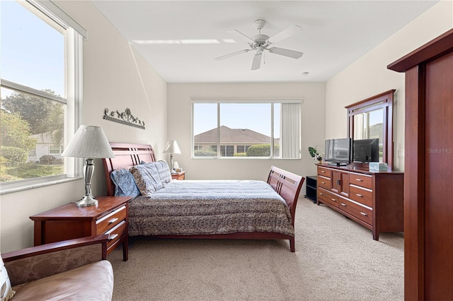 bedroom featuring light carpet and ceiling fan