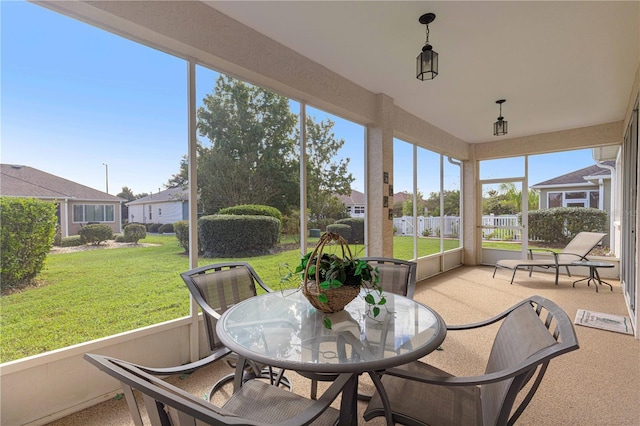 sunroom featuring outdoor dining space