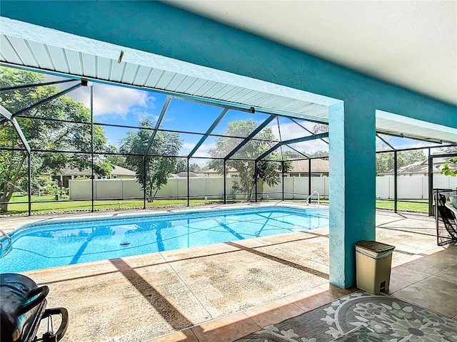 view of swimming pool with glass enclosure and a patio