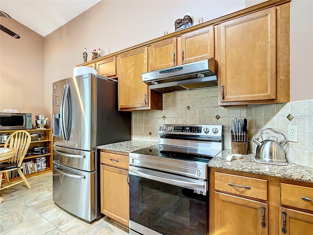 kitchen featuring decorative backsplash, light tile patterned floors, stainless steel appliances, and light stone counters