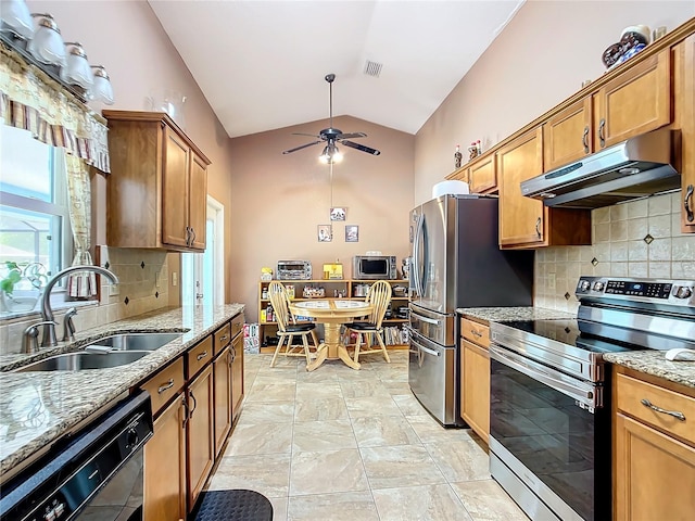 kitchen featuring backsplash, sink, stainless steel appliances, and light stone counters