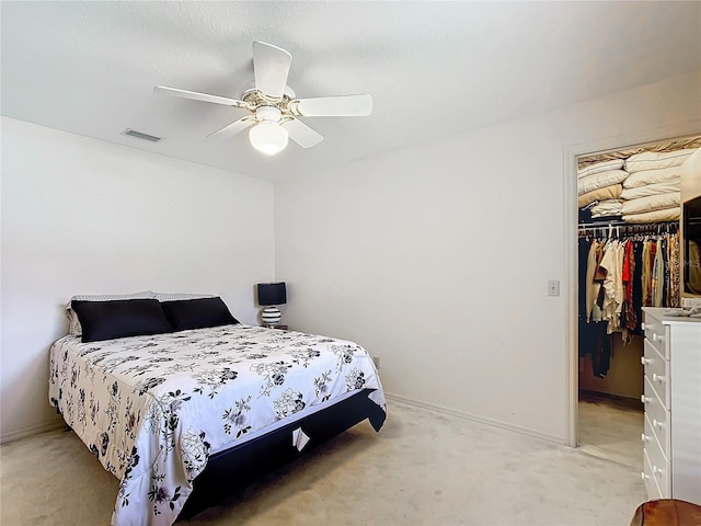 carpeted bedroom featuring ceiling fan and a closet