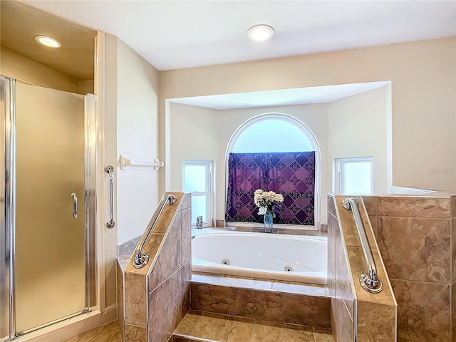 bathroom with independent shower and bath and tile patterned floors