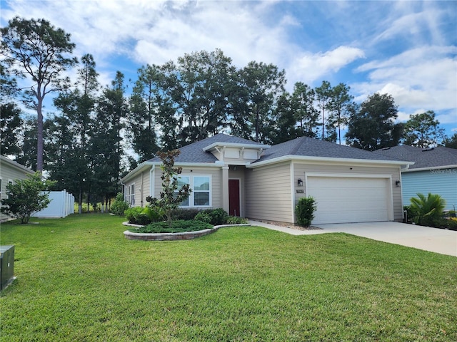 view of front of house with a front yard and a garage