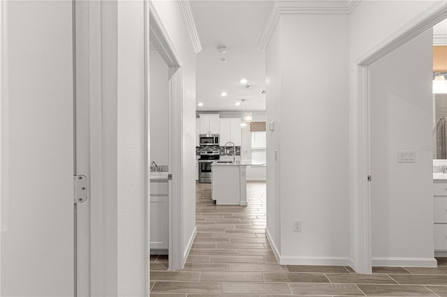 hallway featuring crown molding and sink