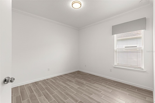 empty room featuring light hardwood / wood-style floors, crown molding, and a textured ceiling