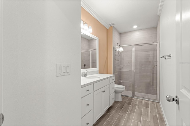 bathroom featuring walk in shower, ornamental molding, vanity, and toilet