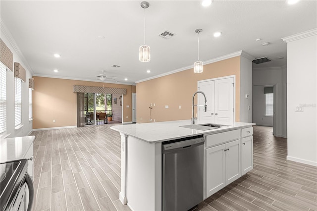 kitchen with an island with sink, sink, white cabinetry, appliances with stainless steel finishes, and light wood-type flooring