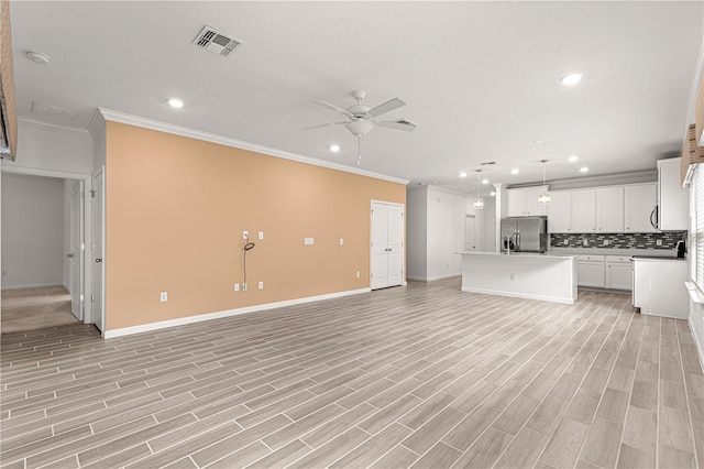 unfurnished living room with ceiling fan, ornamental molding, and light hardwood / wood-style floors