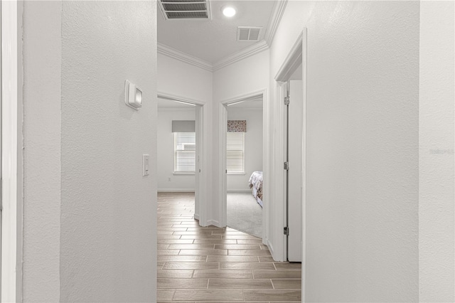 hallway featuring ornamental molding and dark wood-type flooring