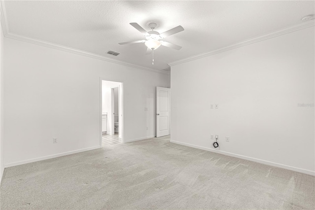 carpeted empty room with crown molding, ceiling fan, and a textured ceiling