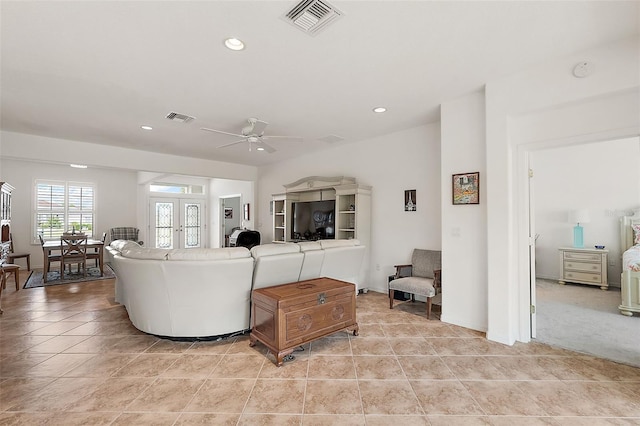 living room with french doors, ceiling fan, and light tile patterned floors