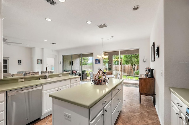 kitchen featuring white cabinets, a kitchen island, decorative light fixtures, stainless steel dishwasher, and sink