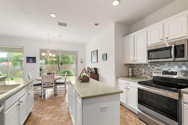 kitchen featuring appliances with stainless steel finishes, white cabinetry, and a wealth of natural light