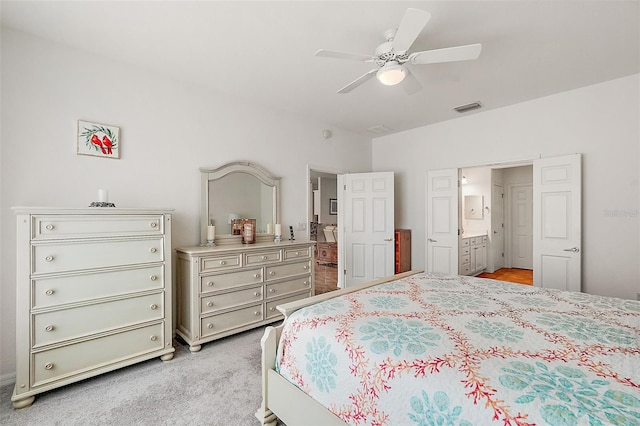 bedroom featuring ceiling fan, light carpet, and ensuite bathroom