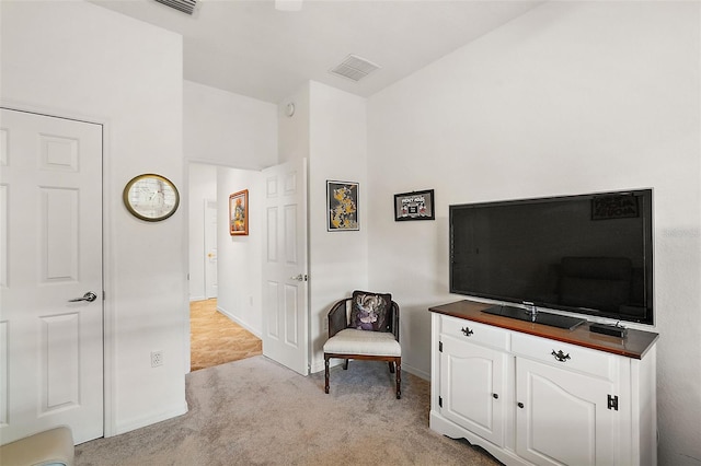 sitting room featuring light carpet