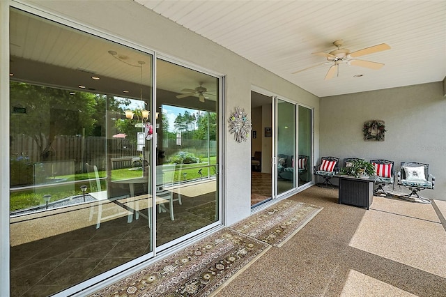 sunroom / solarium featuring ceiling fan