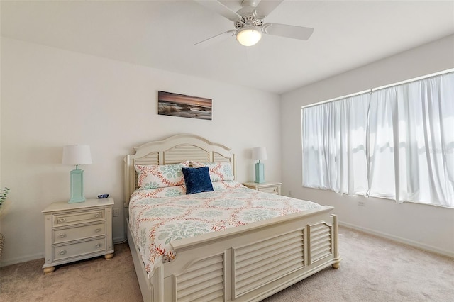 bedroom featuring ceiling fan and light colored carpet