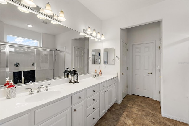 bathroom featuring vanity, a shower with door, and tile patterned floors