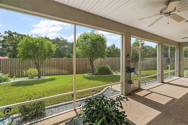 unfurnished sunroom featuring wood ceiling and ceiling fan