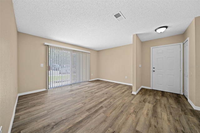 entrance foyer with a textured ceiling and hardwood / wood-style flooring