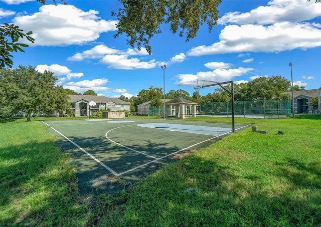 view of basketball court with a lawn