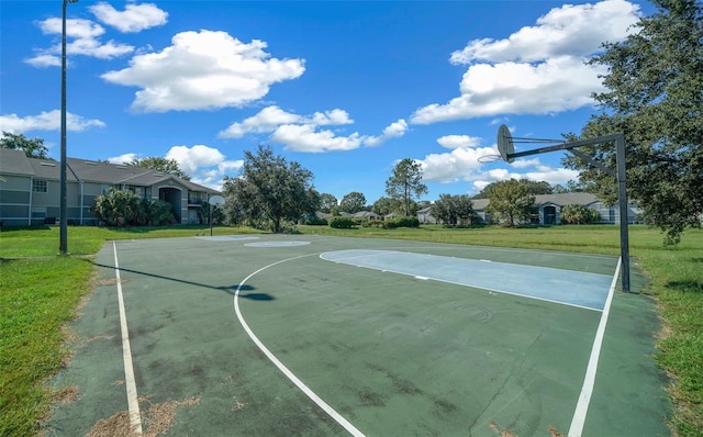 view of sport court featuring a yard