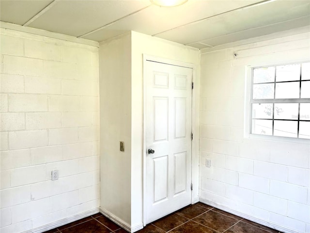 hall with dark tile patterned flooring