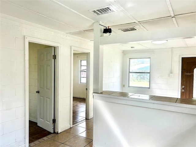 interior space featuring tile patterned flooring and a healthy amount of sunlight