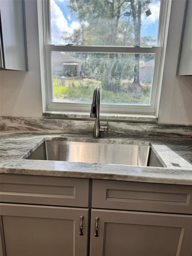 kitchen with sink, gray cabinets, and a healthy amount of sunlight