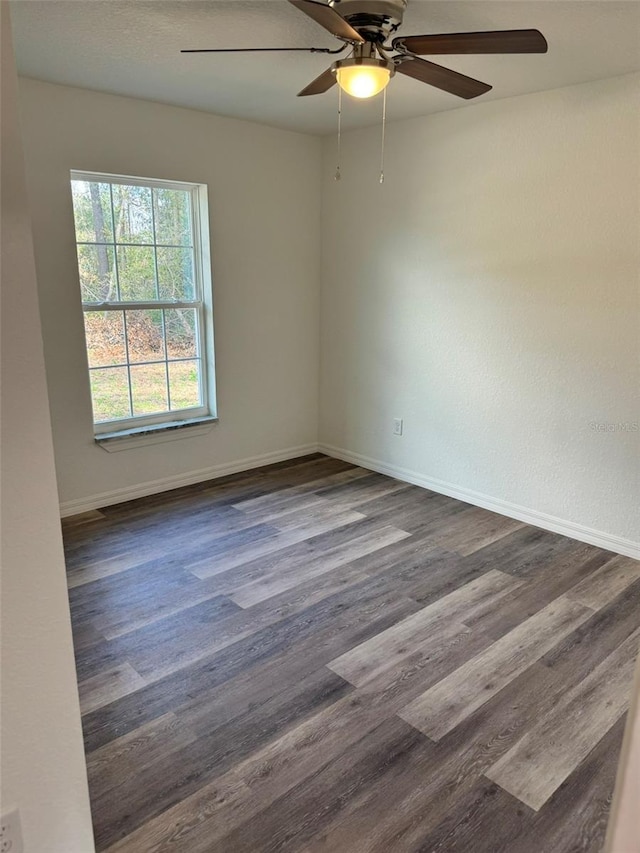 unfurnished room with dark hardwood / wood-style flooring