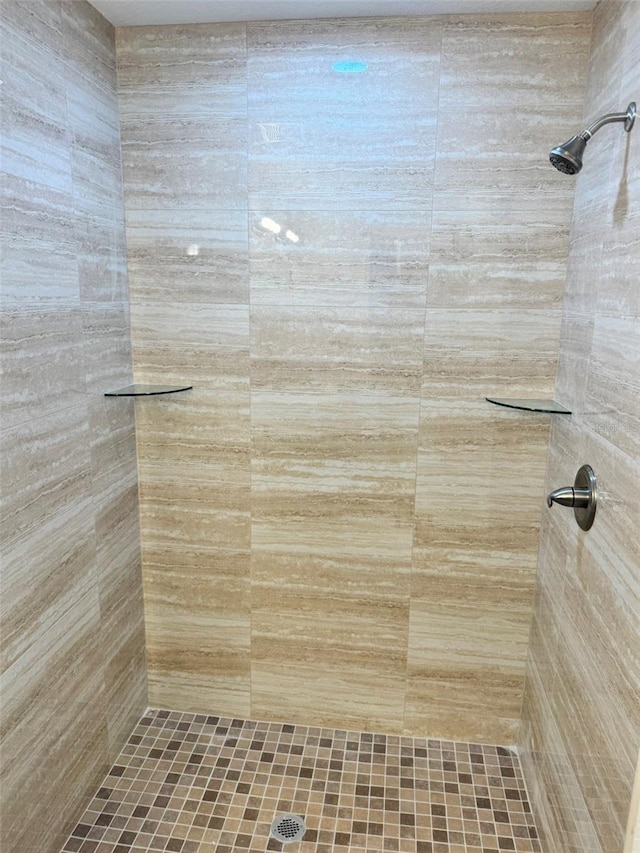 bathroom with a tile shower