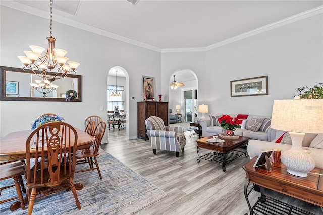 living room with light wood-type flooring and ornamental molding