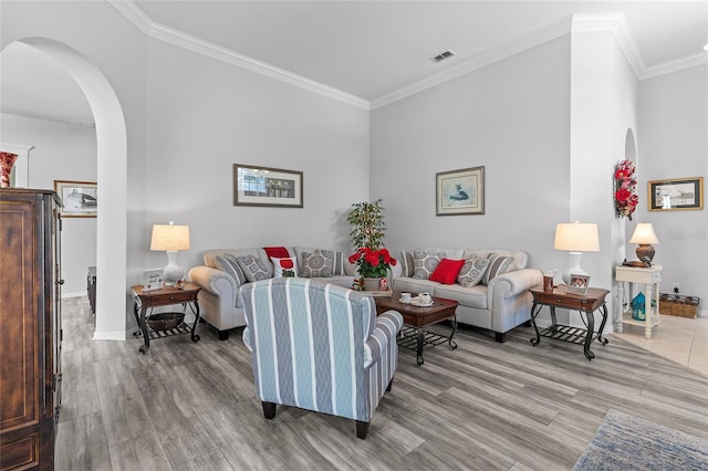 living room with light hardwood / wood-style flooring and crown molding