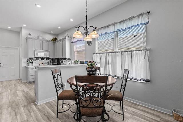 dining room featuring light hardwood / wood-style floors, a chandelier, and a wealth of natural light