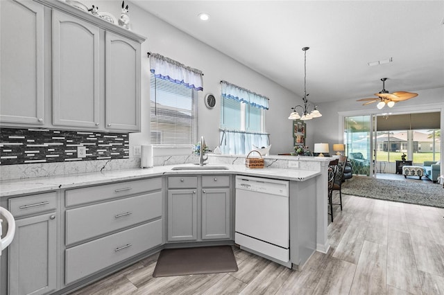 kitchen featuring white dishwasher, light hardwood / wood-style flooring, sink, and gray cabinets