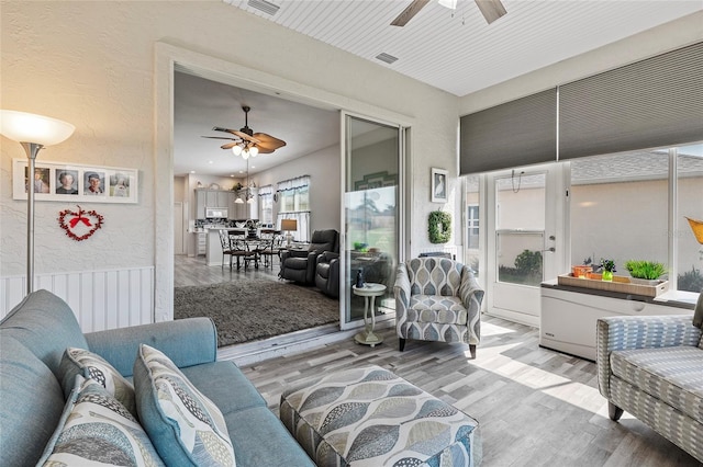 living room featuring light hardwood / wood-style flooring and ceiling fan