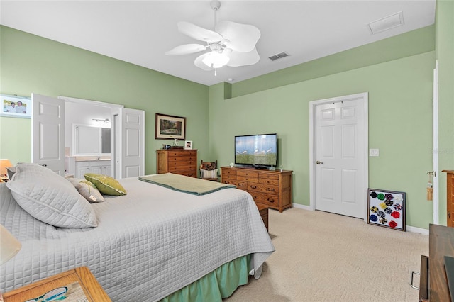 carpeted bedroom with ceiling fan and connected bathroom