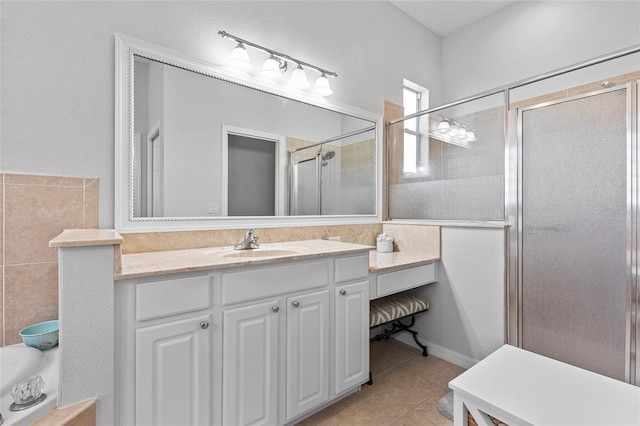 bathroom featuring tile patterned flooring, a shower with shower door, and vanity