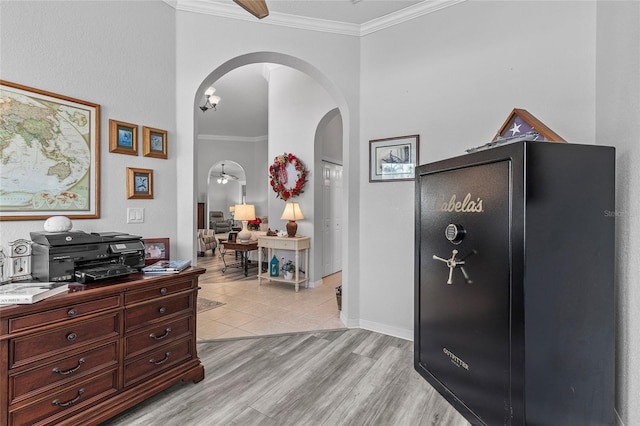 foyer entrance featuring ceiling fan, light wood-type flooring, and crown molding