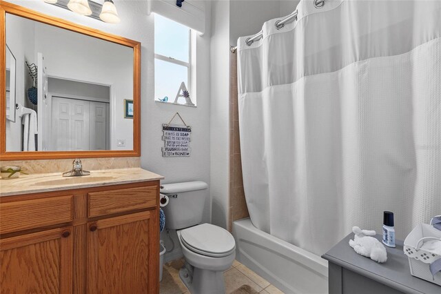 full bathroom featuring shower / bath combo, vanity, tile patterned flooring, and toilet