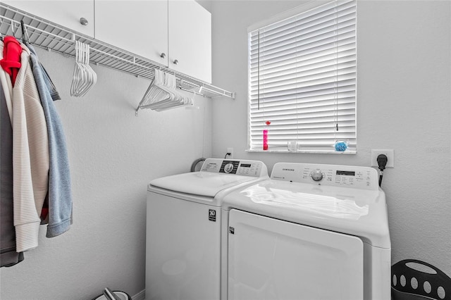 laundry room with cabinets and washer and dryer