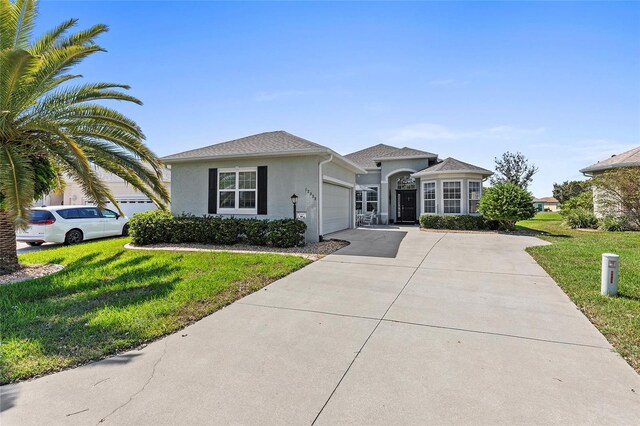 view of front of home featuring a front yard and a garage