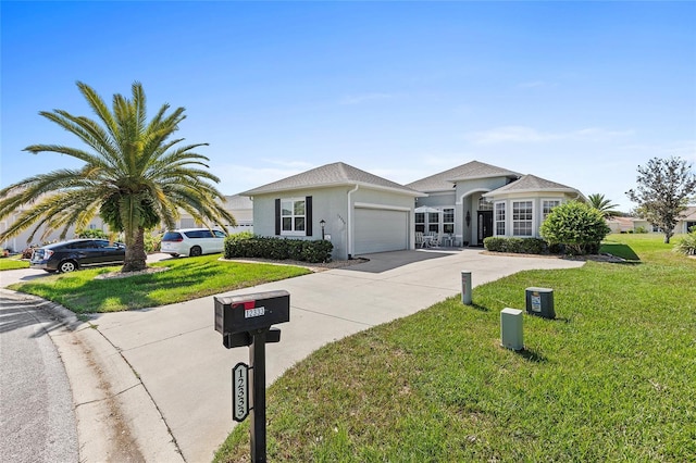 single story home featuring a garage and a front lawn