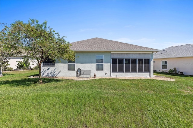 back of house with a sunroom and a lawn