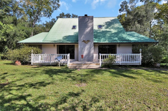 back of house with a lawn and a deck